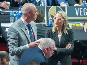 Vancouver Canucks Assistant General Manager Emily Castongay speaks with GM Patrick Allbin during the first round of the NHL Draft in Montreal, Thursday, July 7, 2022.