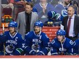 For former Canucks head coach Willie Desjardins (top right), ‘it was like I’ve got to stay out of their way — they know what they’re doing,’ he says of coaching the Sedin twins, pictured on the bench with long-time linemate Alex Burrows (right) during a January 2015 NHL game at Rogers Arena.