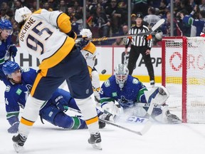 Nashville Predators' Matt Duchene (95) has his shot blocked by Vancouver Canucks' Ethan Bear (74) in front of goalie Thatcher Demko (35) during the first period of an NHL hockey game in Vancouver, on Saturday, November 5, 2022.