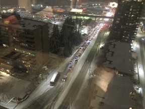 Arleen Chenoll took this photo from her 21st-floor condo, of a stuck transit bus and other drivers failing to make it up Austin Avenue in Coquitlam early Tuesday evening. Cars were slipping and sliding and pulling U-turns, while Good Samaritans tried to help push cars along.