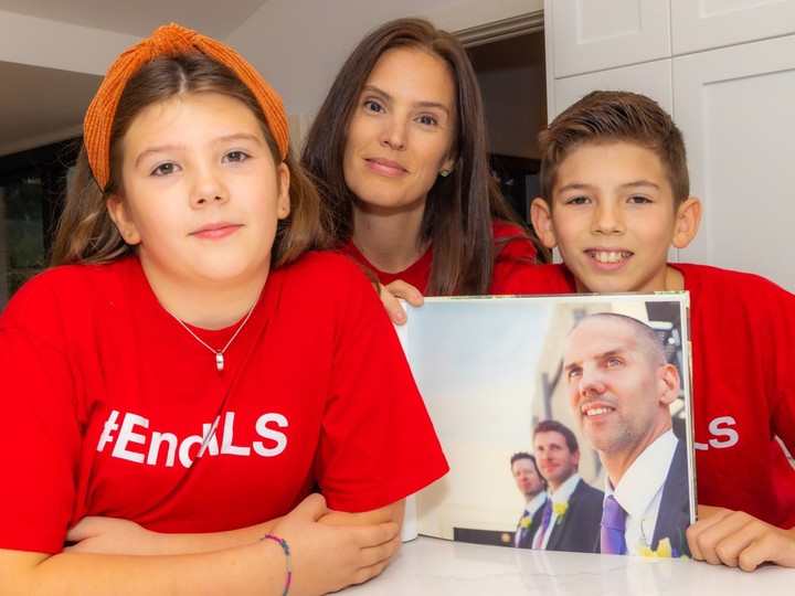  Adrienne Molinski and her children, Maleah, 10, and Micah, 12, wear #EndALS T-shirts and hold a photo of their father.