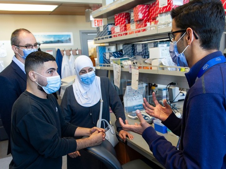  Ebrahim Aldalati, 23, (second from left) and his mother, Falak Aldalat,i meet with researchers Dr. Stuart Turvey (left) and Dr. Mehul Sharma (right) at the B.C. Children’s Hospital Research Institute in Vancouver.