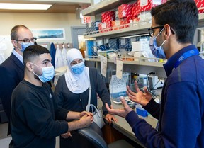 Ebrahim Aldalati, 23, (second from left) and his mother, Falak Aldalat,i meet with researchers Dr. Stuart Turvey (left) and Dr. Mehul Sharma (right) at the B.C. Children’s Hospital Research Institute in Vancouver.
