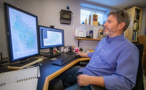 Mr. Clark using the computer setup used to create the map.