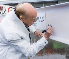 Jimmy Pattison signs one of the beams that will be used in the new building.