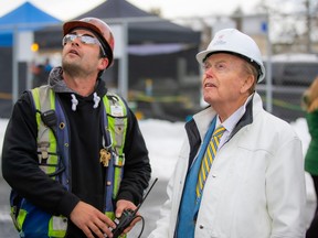 Jimmy Pattison (right) looks at the construction progress with one of the workers.