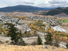The Coldwater River runs through the middle of Merritt, visible by its tree-lined banks.
