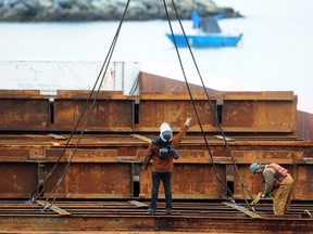 BC Workers removing the final pieces from the stranded barge at English Bay in Vancouver, BC., on November 7, 2022. (NICK PROCAYLO/PNG)