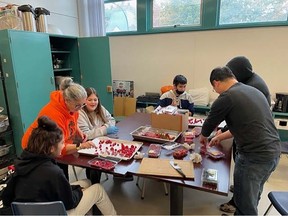 Volunteers prepare food for students at Suwa'lkh Connections. Staff at Coquitlam’s alternative school have been relying on donations of rescued food to feed their 30 students three meals a day — many of whom are impoverished and show up hungry.