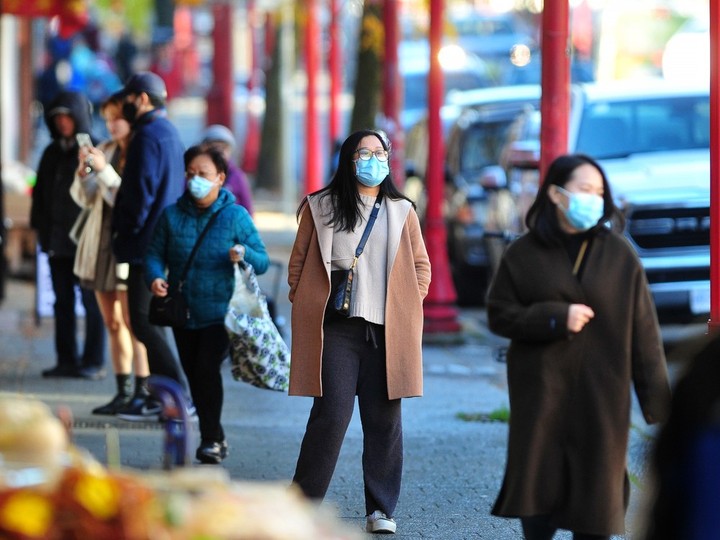  Shoppers are masked up while walking the streets of downtown Vancouver on Monday.