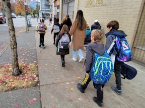 A small band of musicians and their escorts make their way through the streets of the Downtown Eastside towards the Anglican Church of St. James.