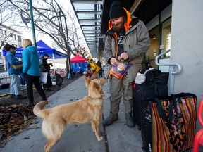 Ryan Moonie, with his dog Alaska, and other DTES residents with pets were treated to pet care by Community Veterinary Outreach at the Evelyn Saller Center on Sunday.