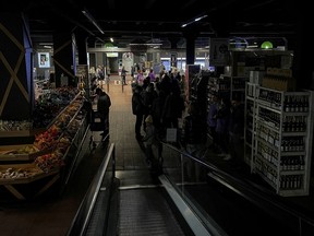 People visit in a supermarket without electricity, after a Russian missile attack, as Russia's invasion of Ukraine continues, in Kyiv, Ukraine October 22, 2022.  REUTERS/Gleb Garanich