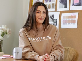 Brunette the Label Founder Miriam Alden wears a sweatshirt from the Brunette the Label x Girlboss collection.