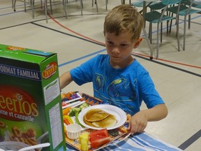 Five-year-old Corbin has been coming to the Terrace Hill Breakfast Club at Graham Bell-Victoria Public School since December. During that time he's learned to love raw carrots. Natasha O'Neill