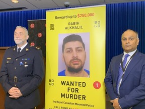 Coquitlam RCMP's Darren Carr with CFSEU chief Manny Mann on Oct. 18, 2022. A $250,000 reward has been offered for the capture of fugitive killer Robby Alkhalil.
