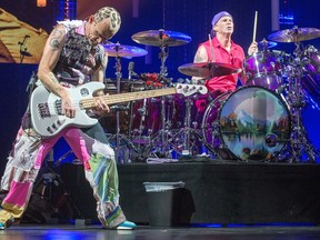 Band members Flea (L) and Chad Smith on stage as the Red Hot Chili Peppers perform at Canadian Tire Centre.  Wayne Cuddington/Postmedia