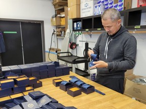 Peter Young packing ties for The Central Intelligence Agency in his South Vancouver premises. Photo: Gerry Bellett.