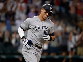 Aaron Judge of the New York Yankees smiles as he rounds the bases after hitting his 62nd home run of the season against the Texas Rangers during the first inning in game two of a doubleheader at Globe Life Field on Oct. 4, 2022 in Arlington, Texas. Judge set the American League record for home runs in a single season.