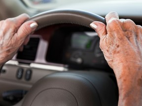 Senior woman hands, driving car, steering wheel - Getty stock photo
