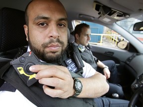 A London Metropolitan Police officer adjusts his bodycam.