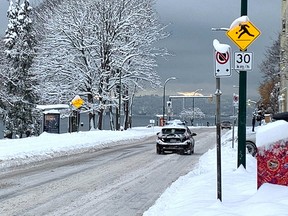 A car traverses Beach Avenue in the West End of Vancouver on Dec. 20, 2022.
