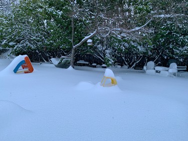 Summer toys in a Victoria backyard are covered were covered in snow on Tuesday morning.