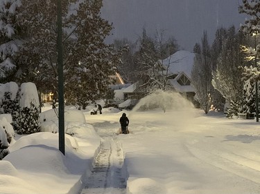 A Fleetwood-area resident uses a snowblower to clear the sidewalk in the early hours of Dec. 20, 2022.