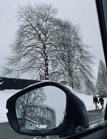 A snow-covered PNE roller coaster is seen through the side mirror of a car on Dec. 20, 2022.