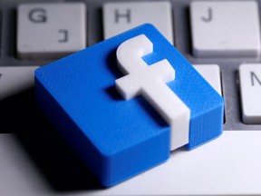 A 3D-printed Facebook logo is seen placed on a keyboard in this illustration taken March 25, 2020. REUTERS/Dado Ruvic/Illustration/File Photo