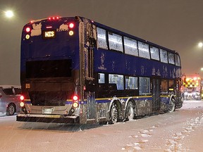 Dozens of vehicles were stranded on the Northbound lanes of the Alex Fraser bridge for several hours due to accumulating snow on Tuesday, Nov. 29, 2022. Crews worked to plow and salt the bridge deck including several transit busses and semi-trucks. Photo: Shane MacKichan