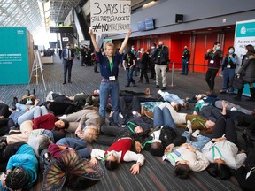 Global Youth Biodiversity Network holds a protest during the United Nations Biodiversity Conference (COP15) in Montreal, Quebec, on December 16, 2022. - Montreal is expected to have at least 10 cm (4 inches) of snow throughout the day. (Photo by Lars Hagberg / AFP)