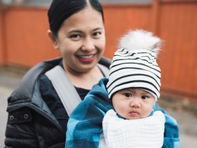 Rayzel, a recent immigrant from the Philippines, holds her infant son Mavi. Photo: Britney Berrner