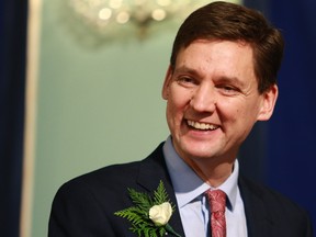 Premier David Eby smiles towards ministers as they are sworn in during a ceremony at Government House in Victoria on Wednesday, December 7, 2022.