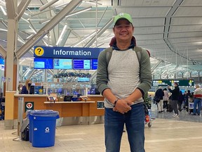 Louie Madlang is pictured at Vancouver International Airport on Friday, Dec. 23, 2022. He, his wife, and five extended family members, arrived Monday Dec. 19 when their connecting flight to Edmonton was cancelled. They weren't able to get a flight out until Christmas..