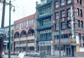 Archival photograph shows buildings and businesses along East Pender Street including 116 East Pender; the Chinese Benevolent Association National Headquarters (108 East Pender); Ho-Ho Chop Suey (102 East Pender); and the Sun Ah Hotel (100 East Pender). Date between 1960 and 1980.