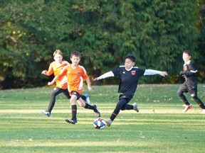 Kids in the Cliff Avenue United FC program in Burnaby in action earlier this year. The club and three others are joining forces in single organization, Burnaby FC, that will make youth development the core of its mission.
