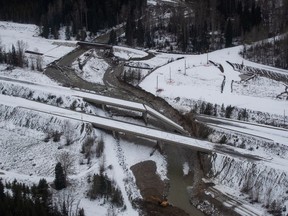 A collapsed section of a bridge sits in the water after severe flooding and landslides on the Coquihalla Highway south of Merritt, B.C., as seen in an aerial view from a Canadian Forces reconnaissance flight on Monday, November 22, 2021.