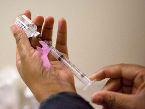 A nurse prepares a flu shot at the Salvation Army in Atlanta, Feb. 7, 2018. The B.C. Centre For Disease Control says there are signs influenza is on a "steady decline" in the province, although case numbers remain high and positive tests rates for respiratory syncytial virus continue to rise.