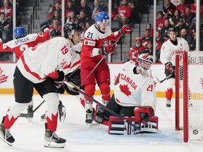 Czechia's Jaroslav Chmelar (centre) celebrates a goal in front of Canada's goaltender Ben Gaudreau and Adam Fantilli during the first period at the IIHF world junior hockey championship Monday in Halifax.