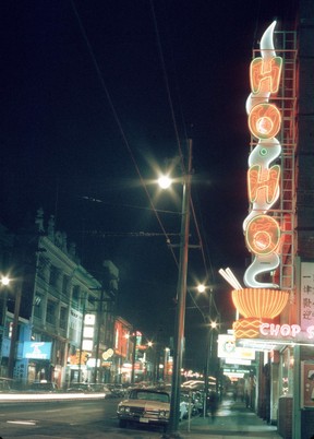 Archival photo showing the neon Ho-Ho Chop Suey Restaurant sign on 102 E. Pender St. Date between 1960 and 1980.