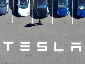 Brand new Tesla cars sit in a parking lot at the Tesla Inc. factory in Fremont, California.