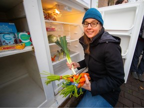 Anyone can donate food to the community pantry, says volunteer Mona Grenier.  Volunteers also stock coolers with unwanted but not expired items from local markets.