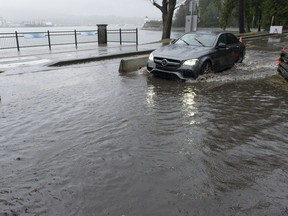 FILE PHOTO: A car drives through flooding in Stanley Park in December.