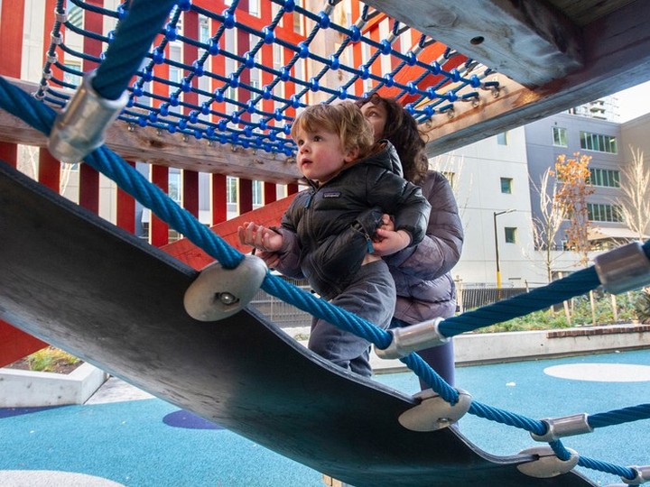  Leo Fumano, 2, gets a helping hand from cousin Layla Humayun, 10, while playing at Rainbow Park in Vancouver in a file photo from 2022.