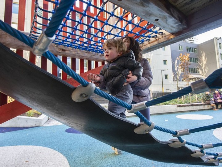  Leo Fumano, 2, gets a helping hand from Layla Humayun, 10, while playing at sθәqәlxenәm ts’exwts’áxwi7, also known as Rainbow Park, in Vancouver on Wednesday.