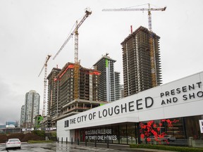 File photo of towers under construction beside The City of Lougheed Shopping Centre, which is experiencing a partial power outage after last weekend's storm.