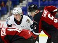 Vancouver Giants defenceman Carson Haynes battles for position with Portland Winterhawks forward Nicholas Johnson (left) at a faceoff during the Giants-Winterhawks WHL game at the Langley Events Centre on Nov. 27, 2022.