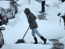 Residents on Dundas St shovel snow during an early morning power outage in Vancouver, BC., December 19, 2016.   