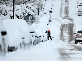 Vancouver residents clear sidewalks outside their homes on Dec. 20. 2022.